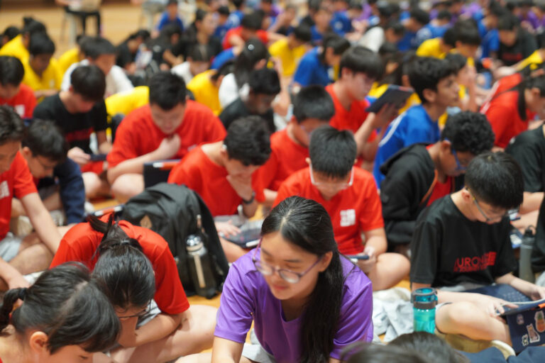 Students playing and voting for games in the school hall