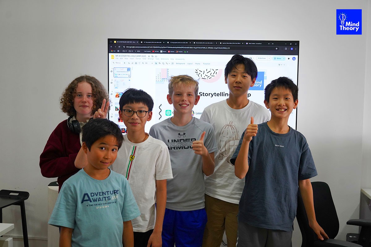 Six smiling children pose in front of a large screen displaying a presentation