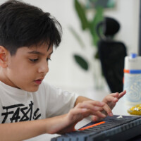 Young boy focused on typing on a keyboard at a desk