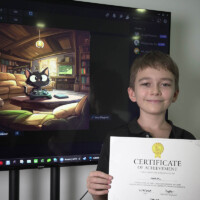 Boy holds certificate, smiling beside large screen displaying cartoon cat