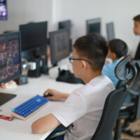 Young people work at computers in a tech-focused workspace