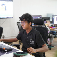 Young boy focused on computer screen in office setting