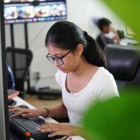 Young woman focused on computer work in office setting