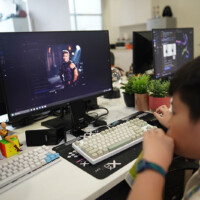 Child focused on computer screen displaying animated character