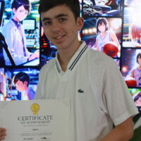 Young man holds achievement certificate in front of anime-themed screens